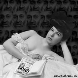 Young woman, wearing negligee, lying in bed, holding book, with OSAMA BIN LADEN!!